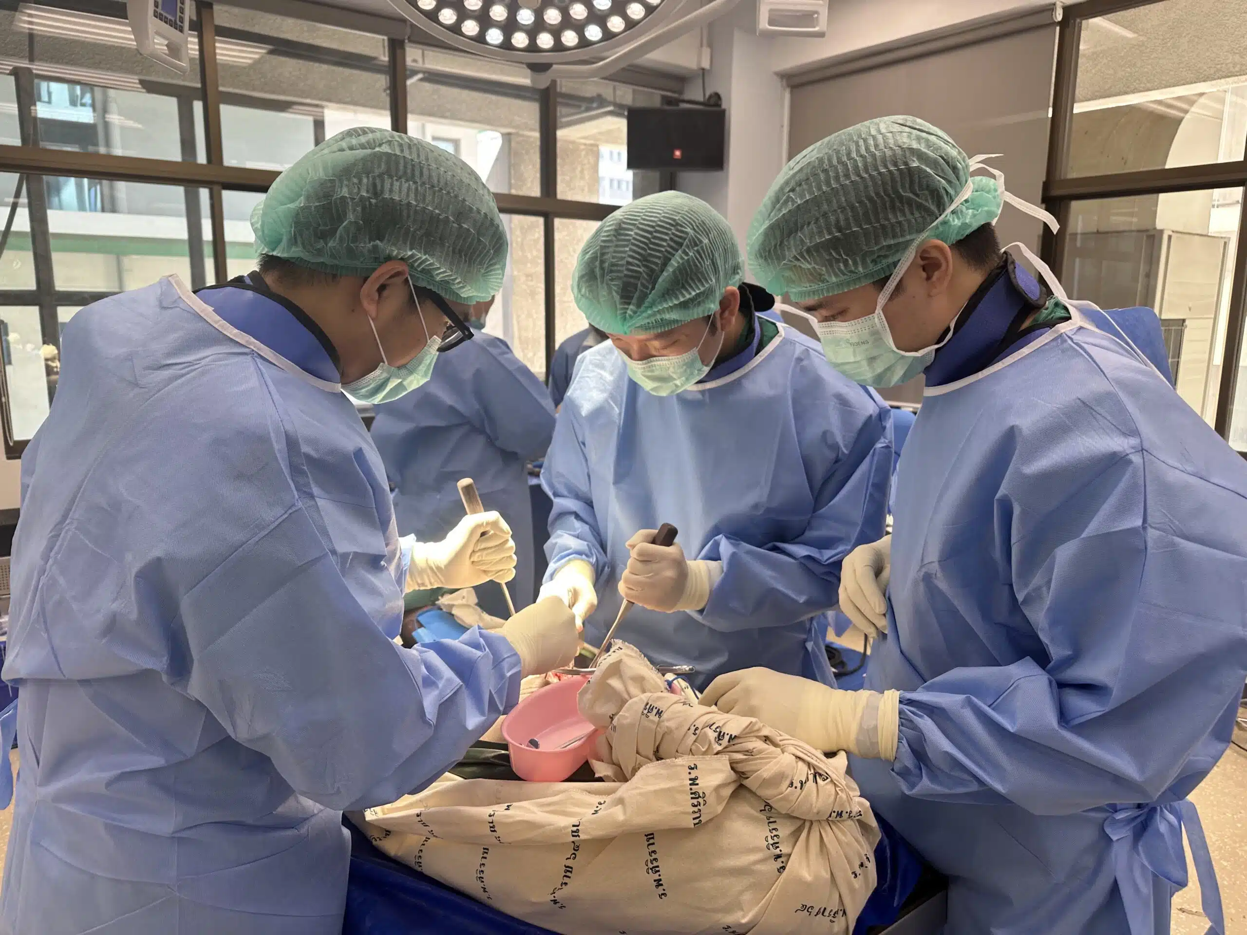 Spine surgery workshop, medical team practicing surgical techniques in operating room